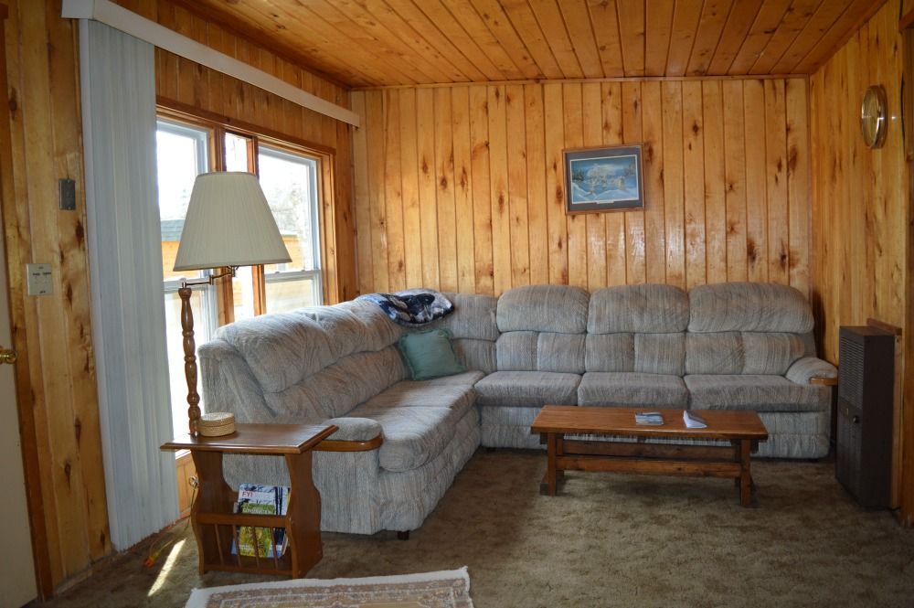a living room with a sectional couch and a coffee table