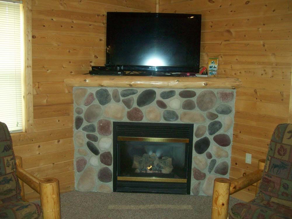 a living room with a fireplace and a flat screen tv