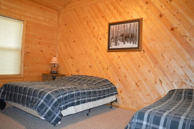 a bedroom with two beds and a picture on the wall