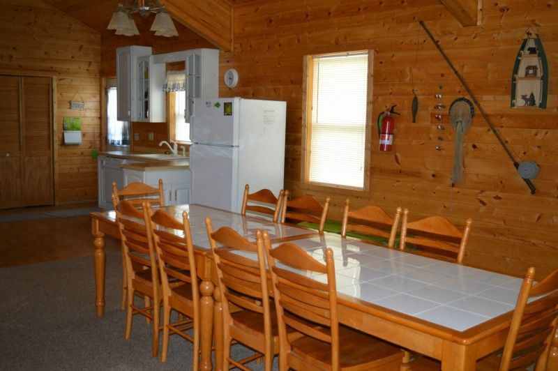 a kitchen with a table and chairs and a refrigerator