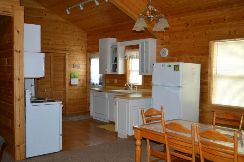 a kitchen with a table and chairs and a refrigerator