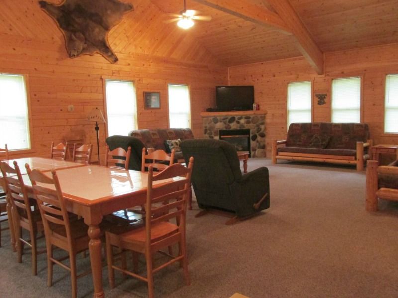 a living room with tables chairs and a fireplace