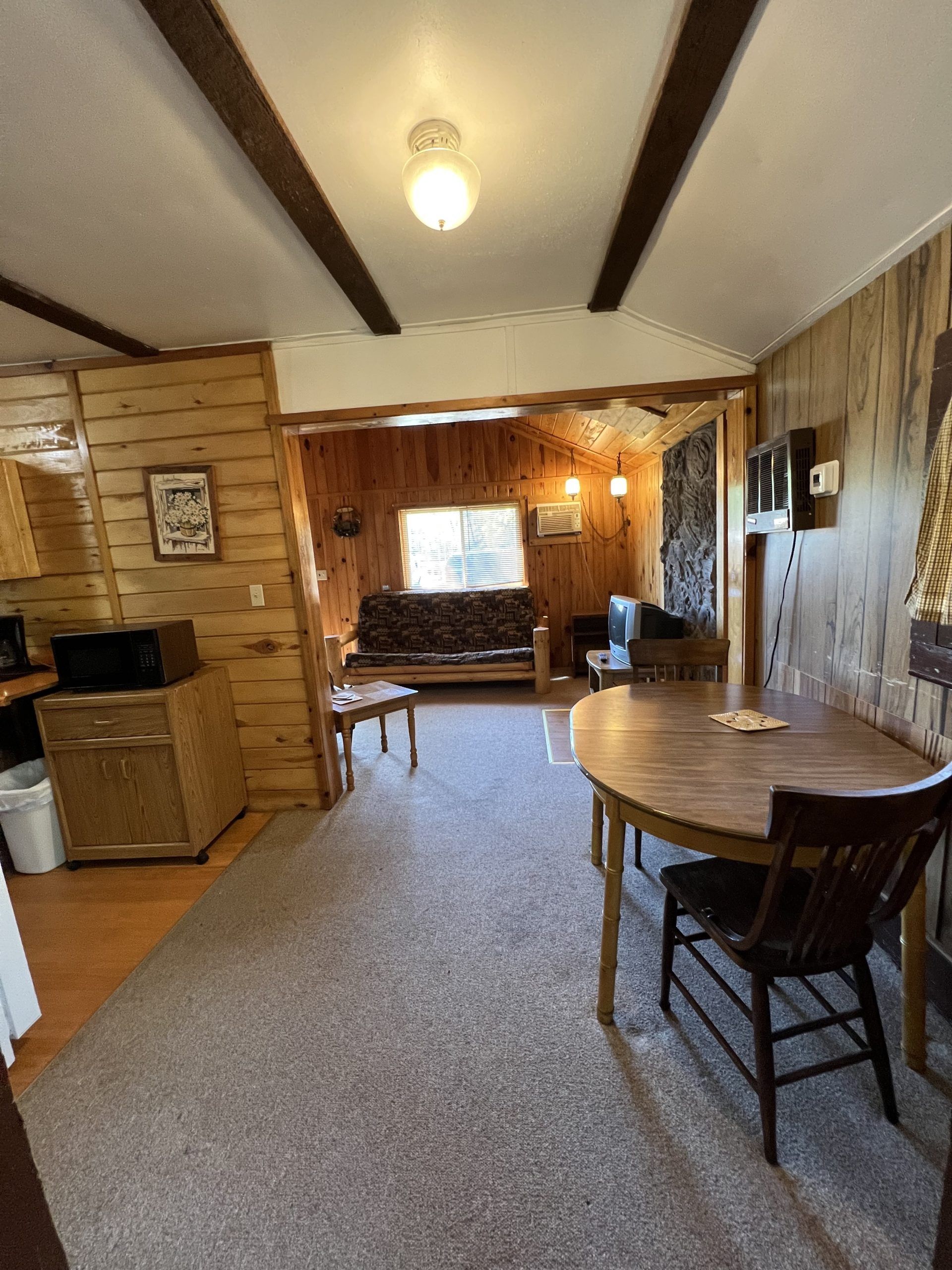 there is a table and chairs in the middle of the room