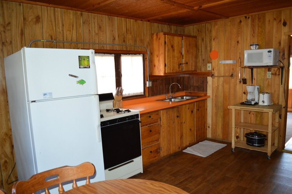a kitchen with wooden cabinets and a white refrigerator