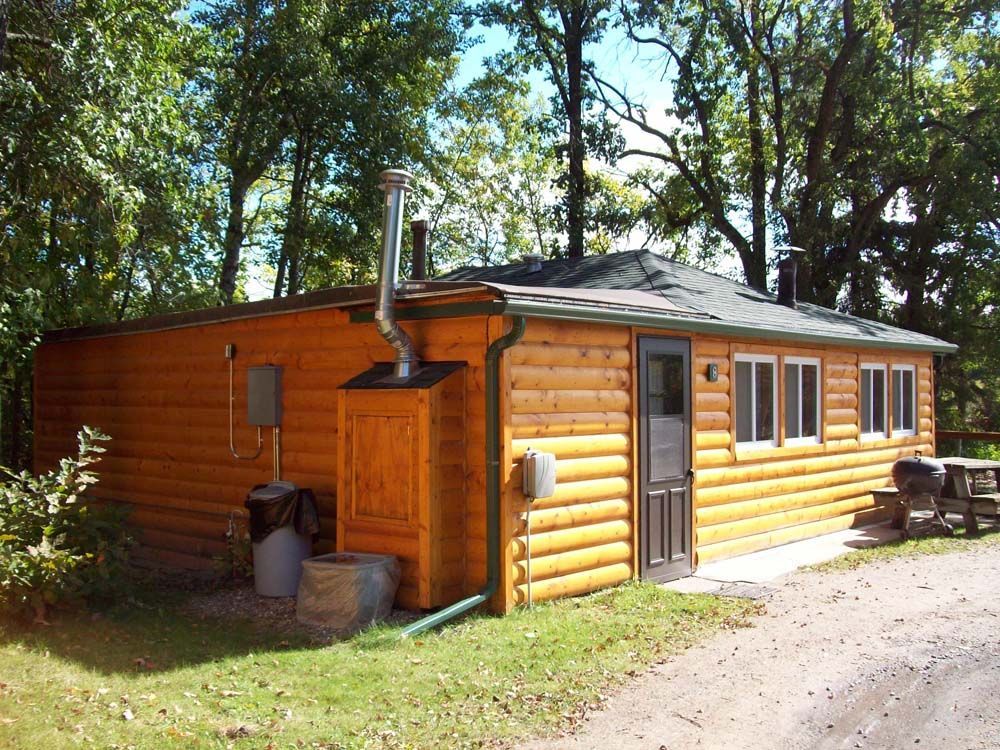 a log cabin in the middle of a forest