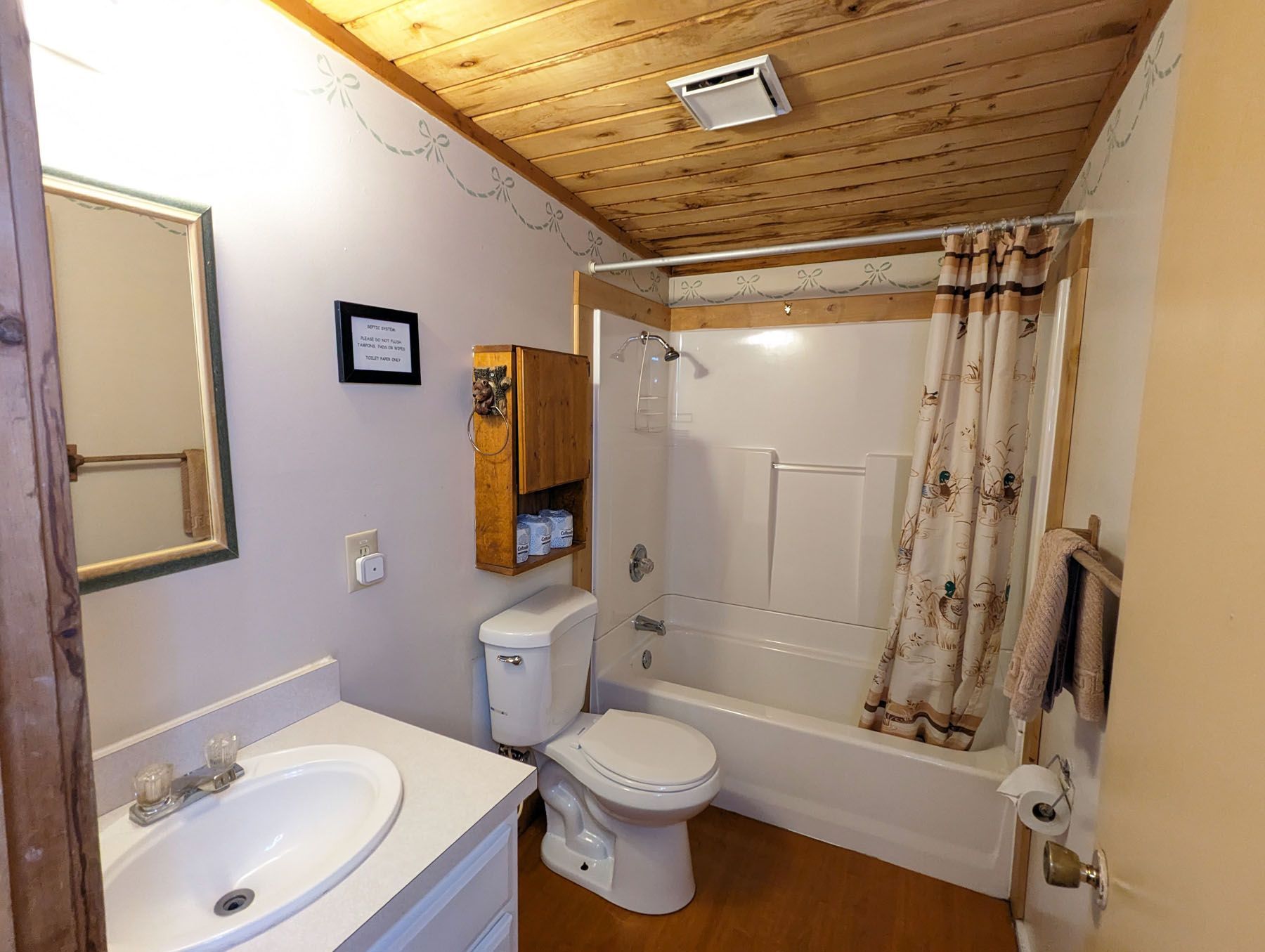 a bathroom with a toilet, sink, and bathtub