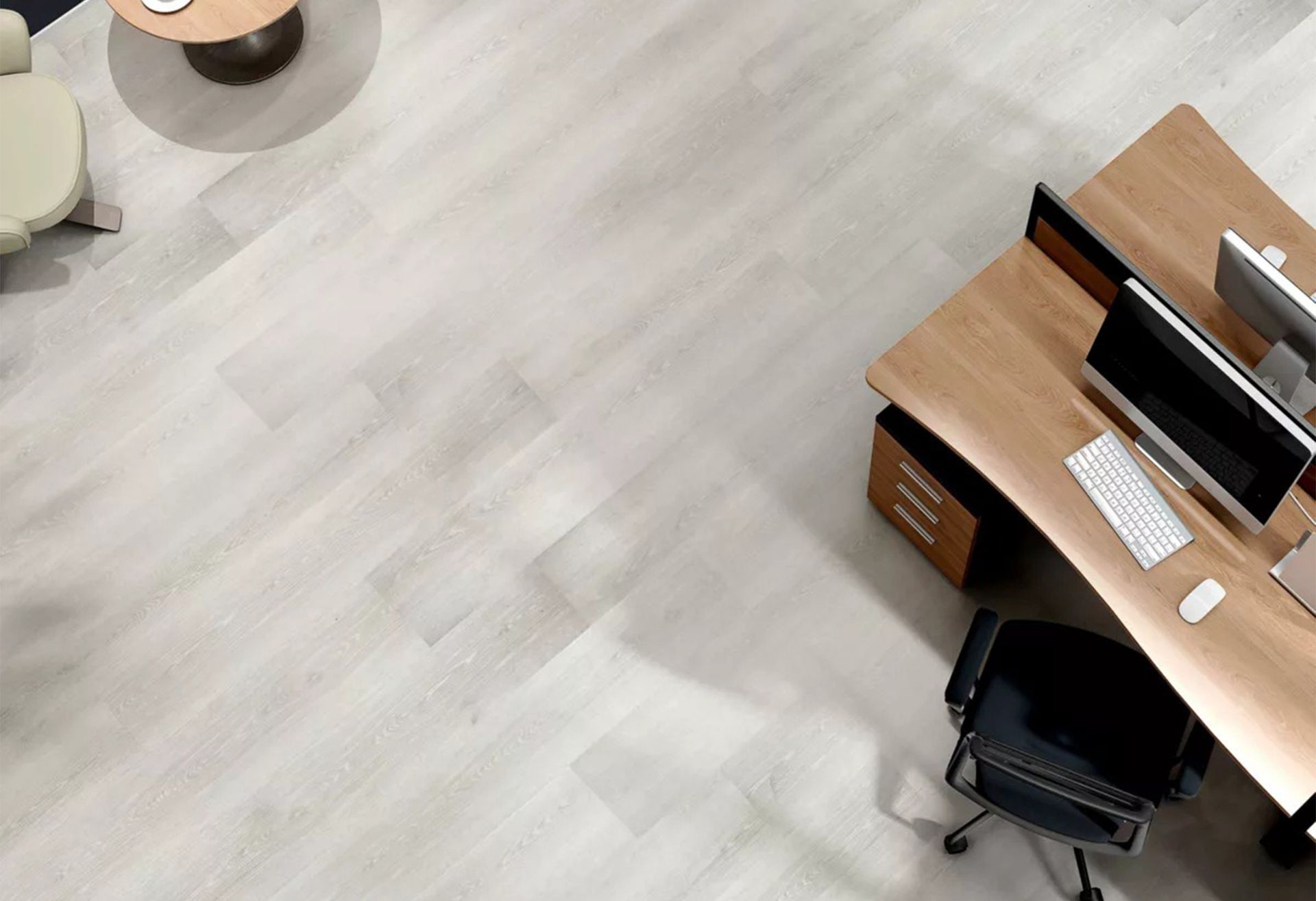 An aerial view of an office with two desks and two computers