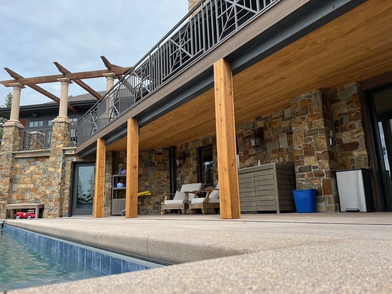 A large house with a swimming pool in front of it