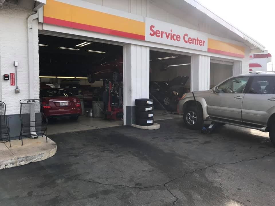 Auto service center garage with cars inside and parked outside