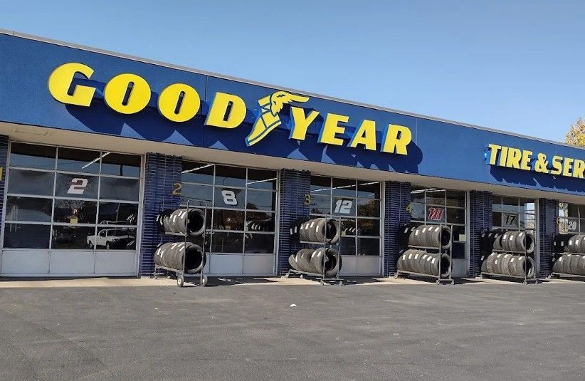 Goodyear tire and service store storefront with stacked tires outside