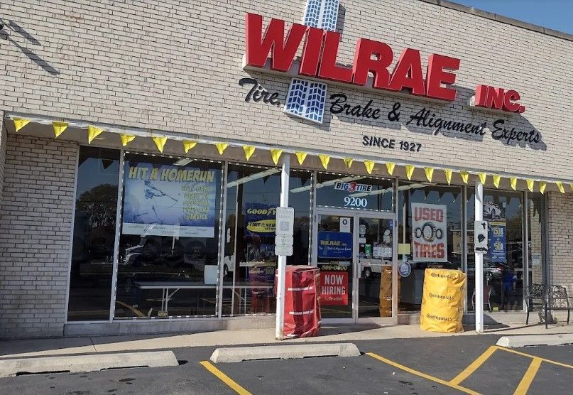 Wilbrae Inc. storefront with glass windows, red sign, and yellow pennants over the entrance