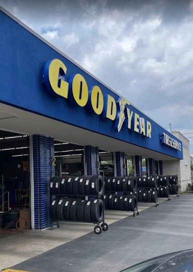 Goodyear tire store with blue awning and rows of tires displayed outside