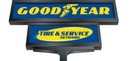 Goodyear Tire & Service Network sign in yellow and blue on a roadside pole
