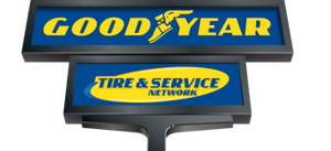 Goodyear Tire & Service Network sign in yellow and blue on a roadside pole