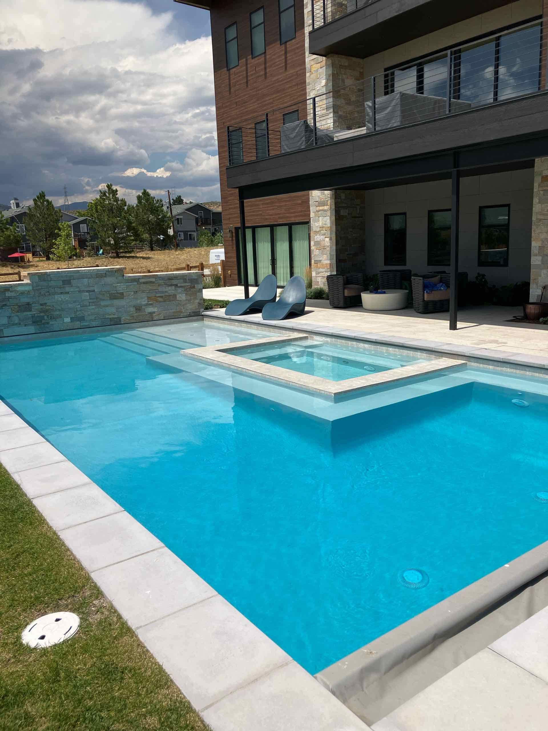 A large swimming pool in front of a large building