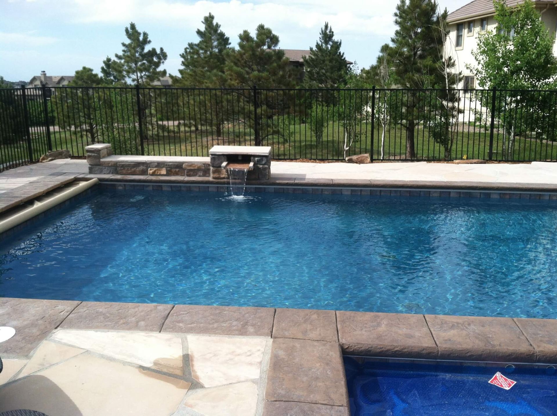 A large swimming pool with a fence around it.