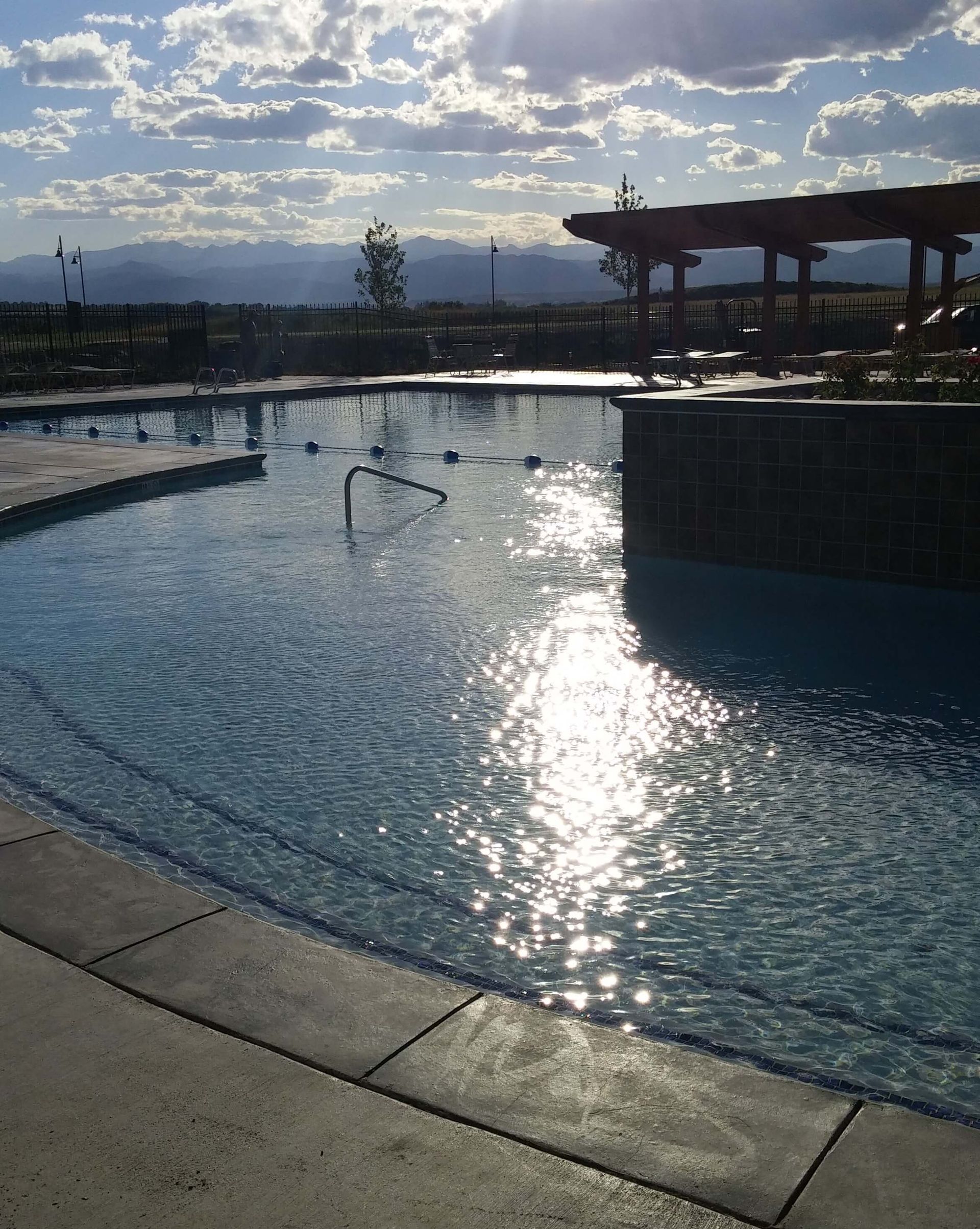 A large swimming pool with mountains in the background.