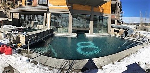 A large swimming pool with the number 8 written in the water.