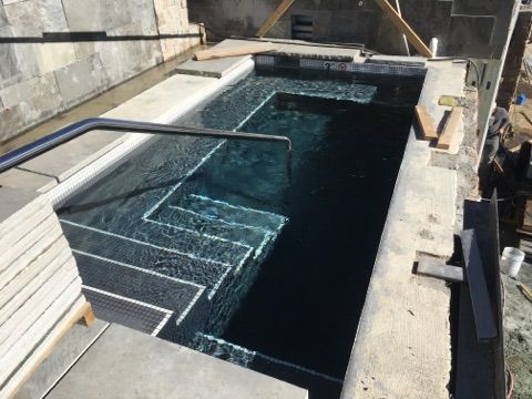 A large swimming pool with stairs leading up to it