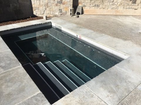 A swimming pool with stairs leading up to it