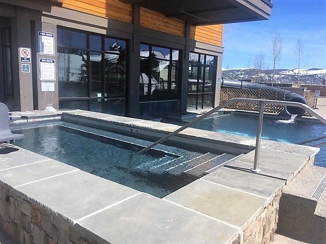 A large hot tub is sitting outside of a building.