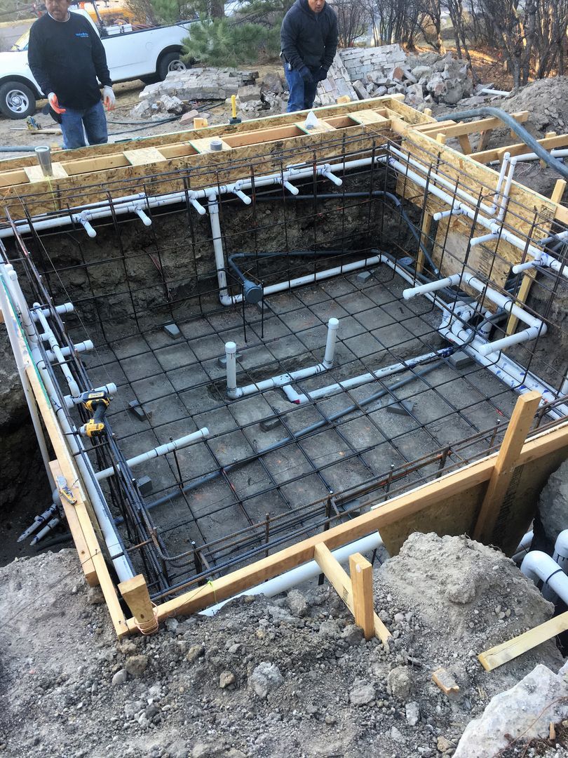 A swimming pool is being built in a hole in the ground.