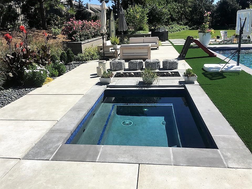 A large swimming pool with a small pool in the middle.