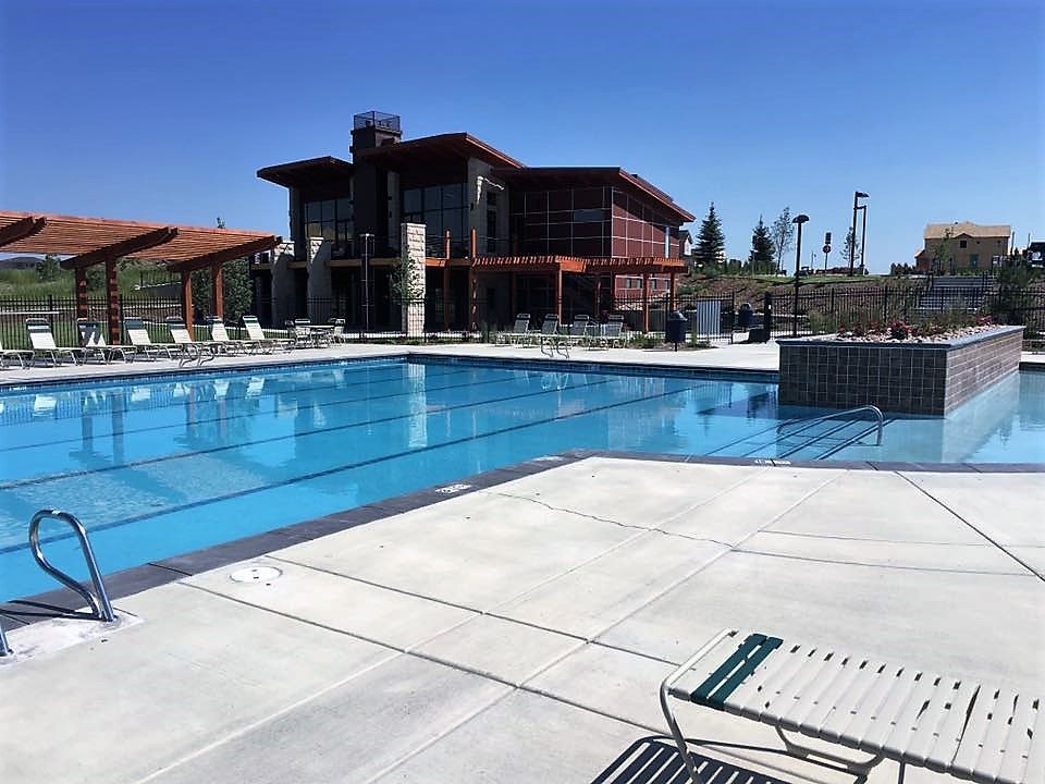 A large swimming pool with a building in the background.