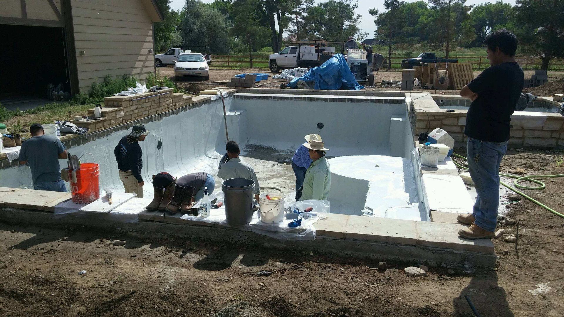 A group of men are working on a swimming pool.