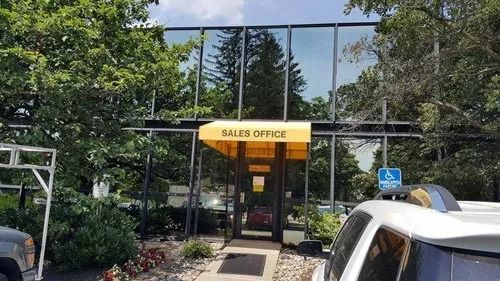 Office building with a yellow awning above the entrance; 