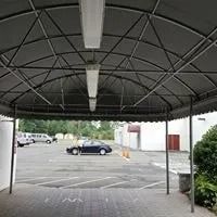 A covered parking area with a car parked.