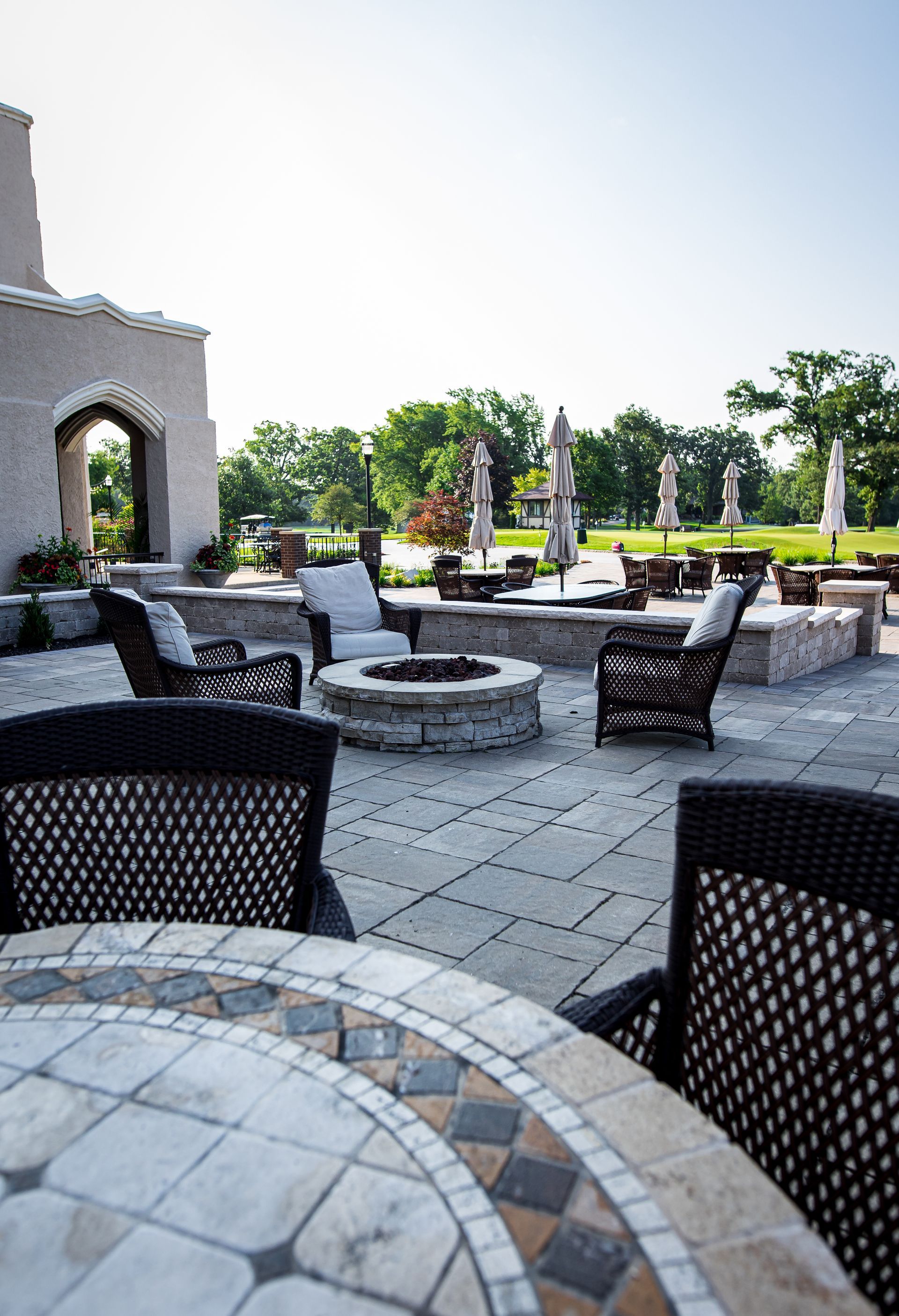 There is a fire pit in the middle of the patio.