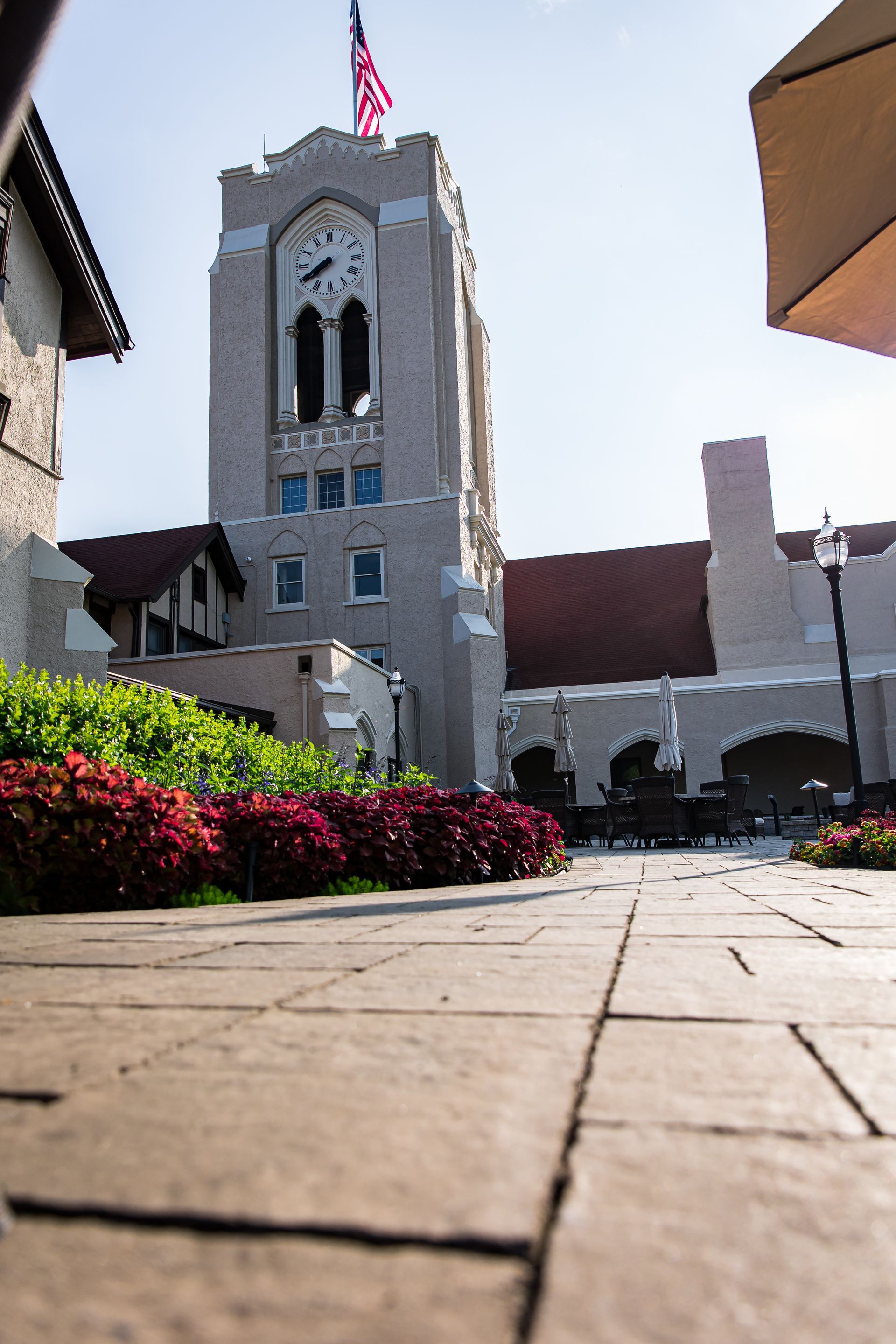 A clock tower with a flag on top of it