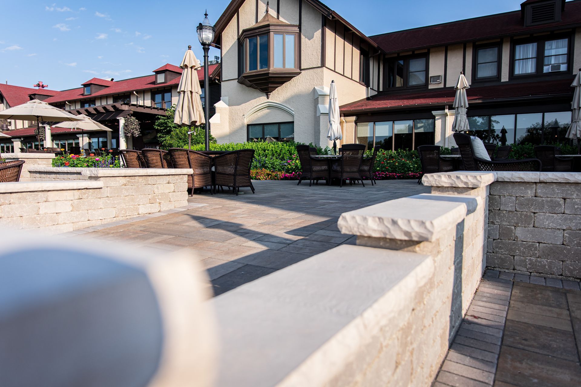 A large building with a lot of windows and umbrellas in front of it.