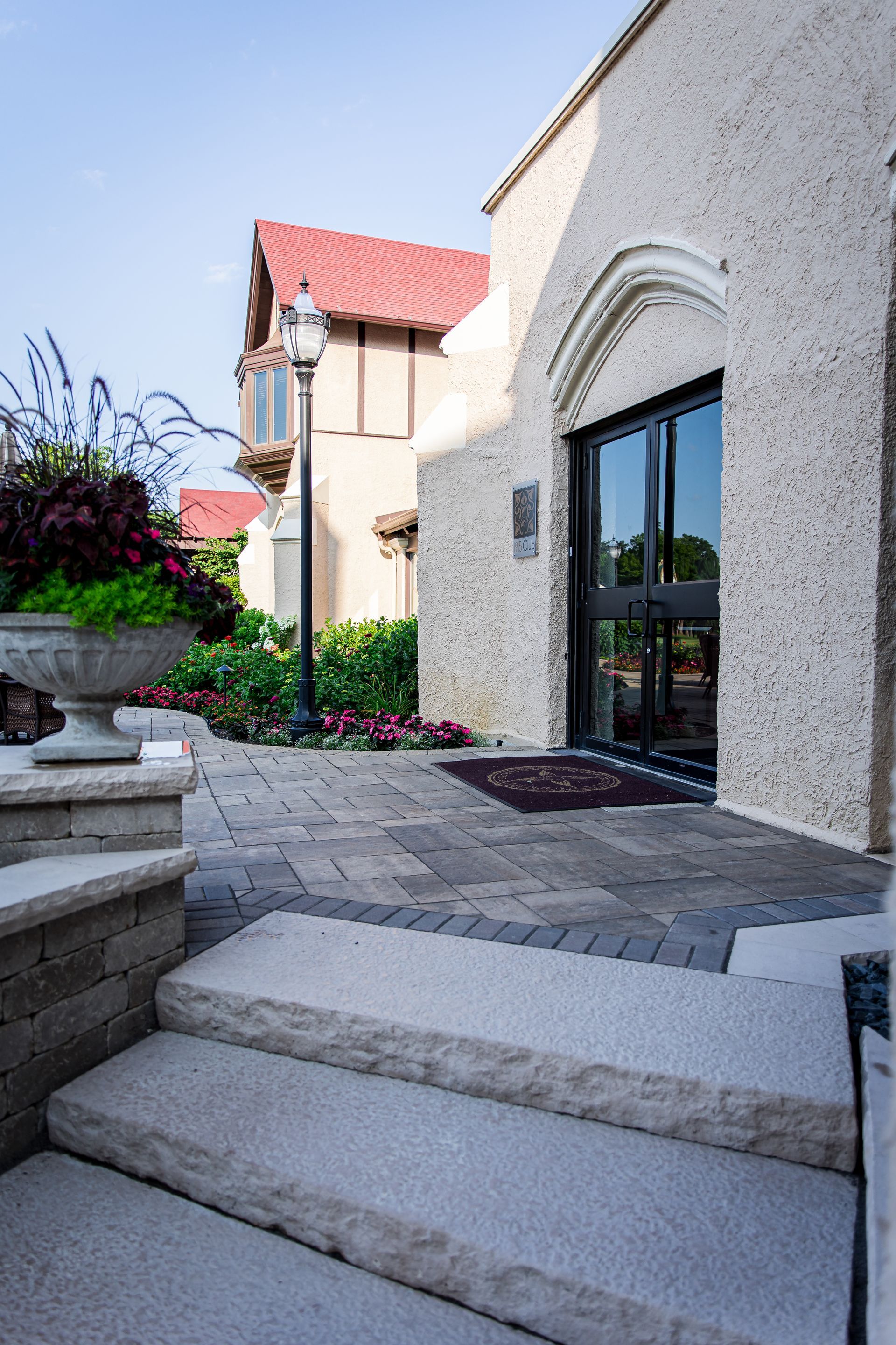 There are stairs leading up to a building with a red roof.