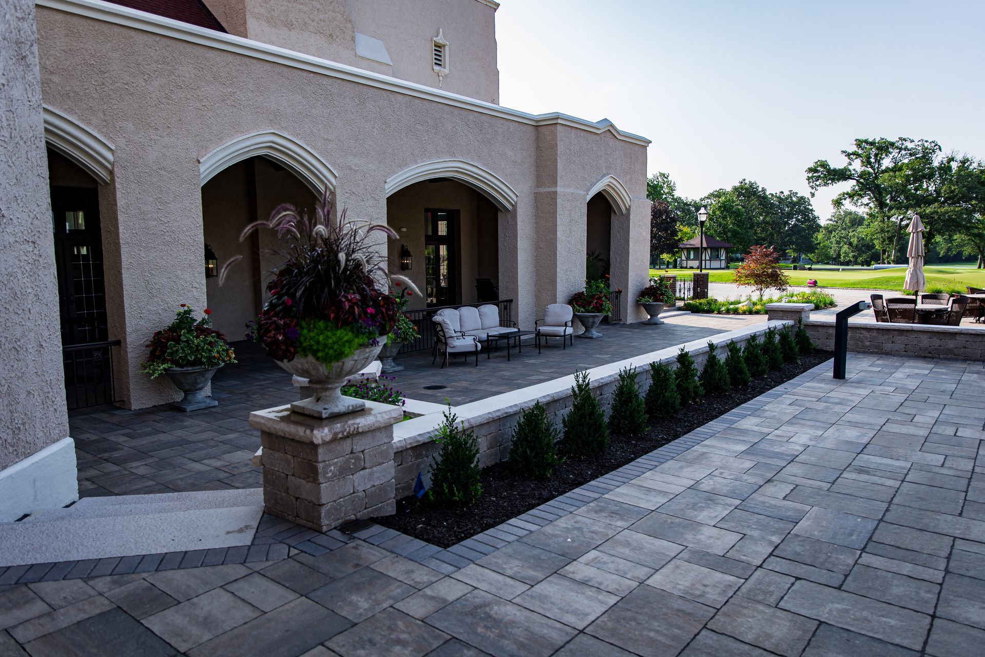 A large building with a patio in front of it.