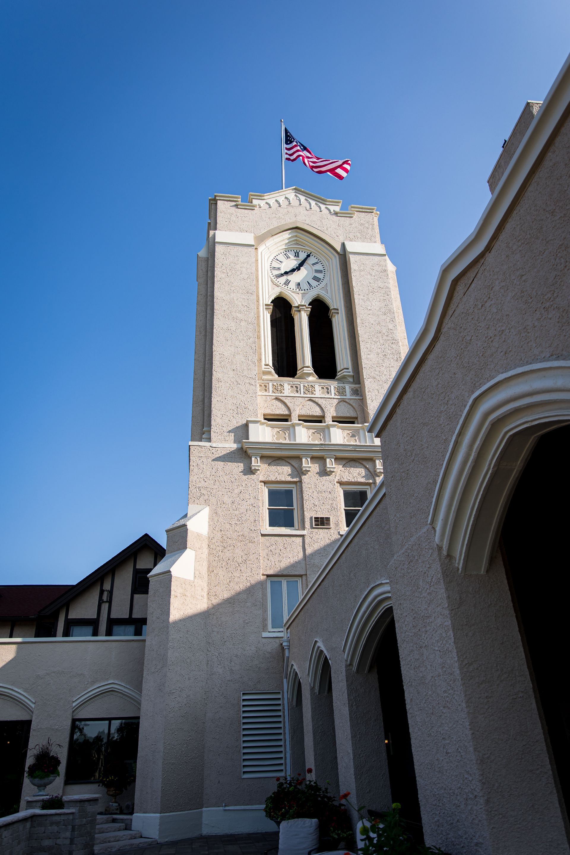 A clock tower with an american flag on top of it