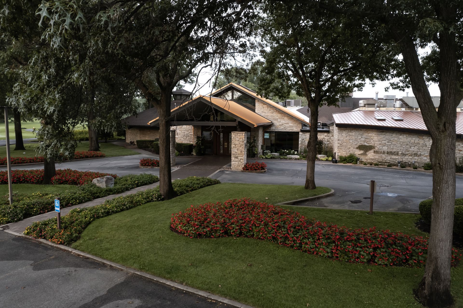 A large building with a lot of flowers in front of it