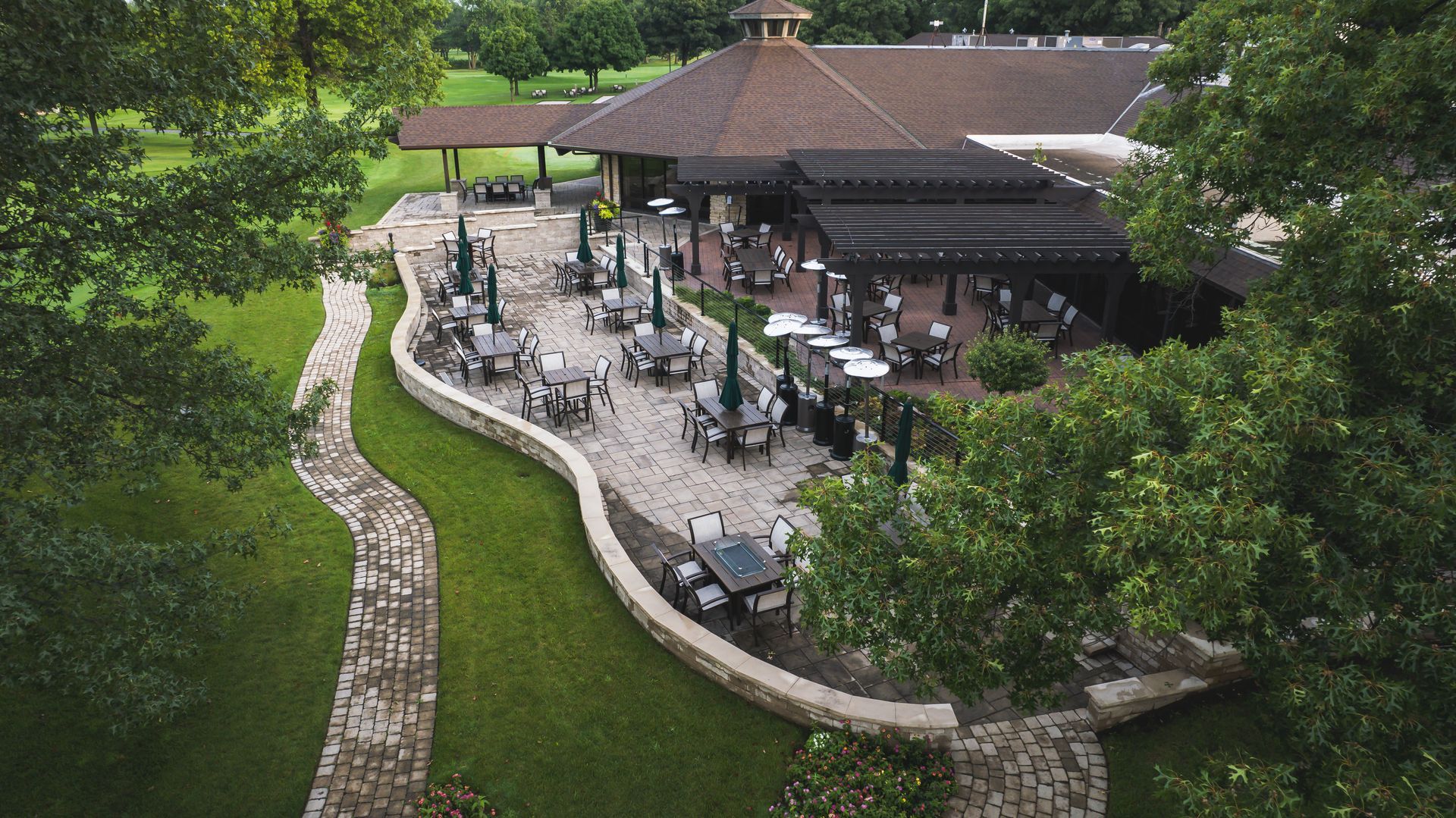 An aerial view of a restaurant with tables and chairs on the patio.