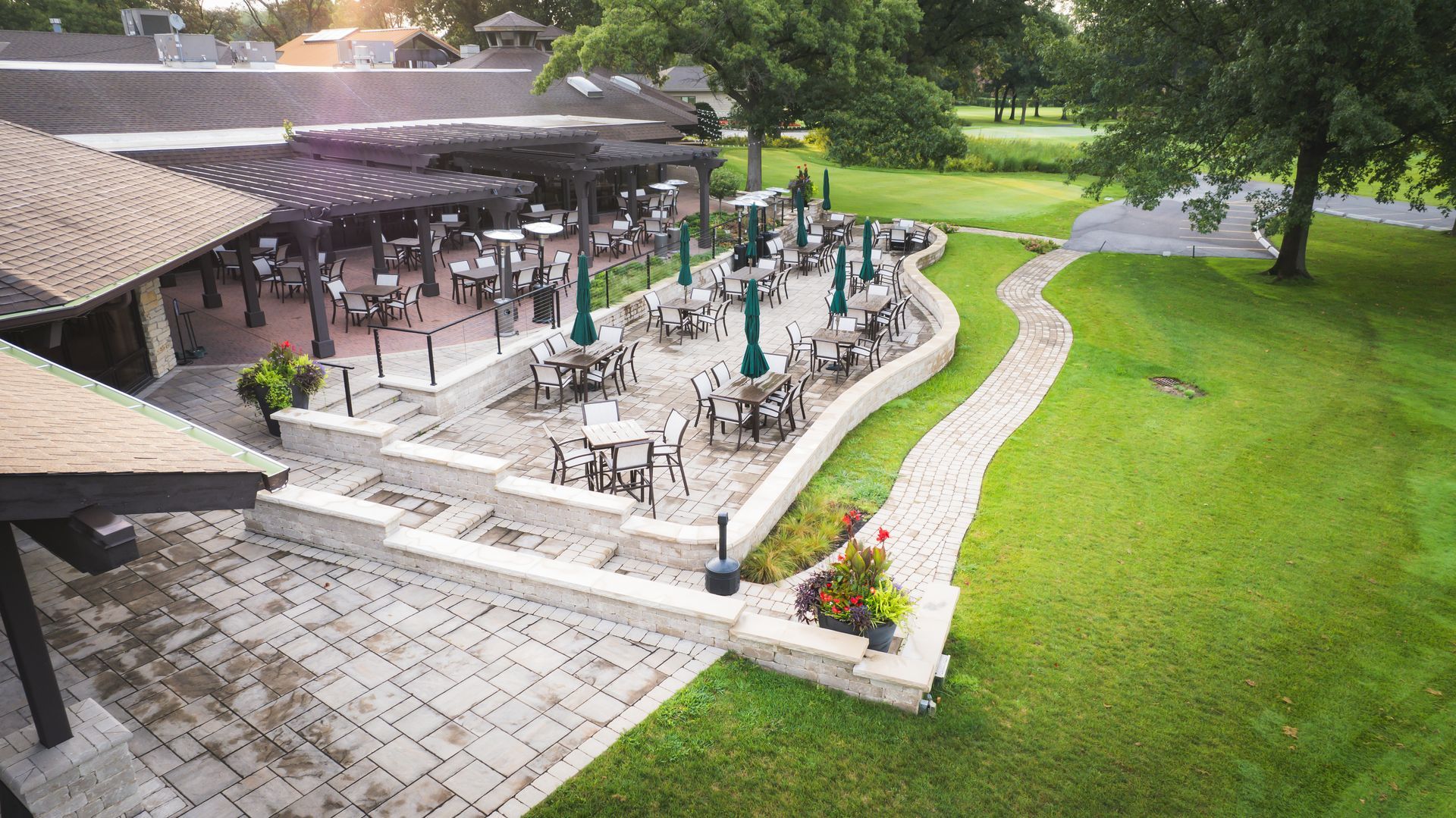 An aerial view of a patio area with tables and chairs and umbrellas.