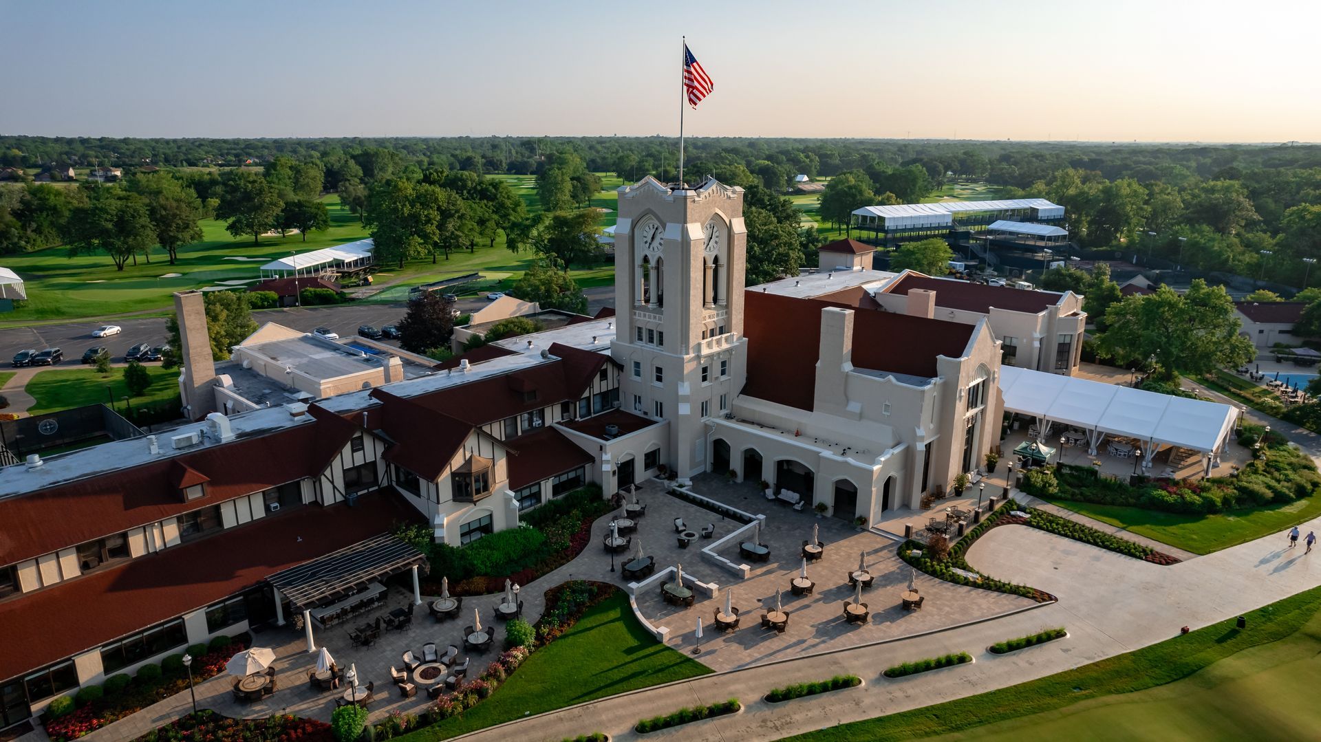An aerial view of a large building with a flag on top of it.