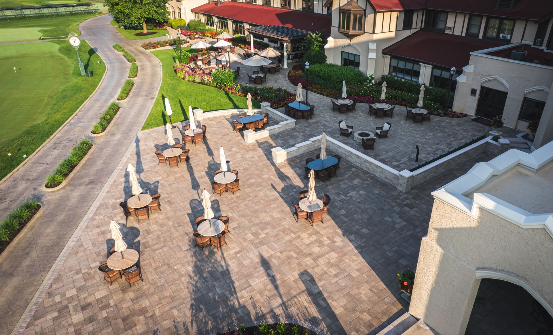 An aerial view of a patio with tables and chairs and umbrellas
