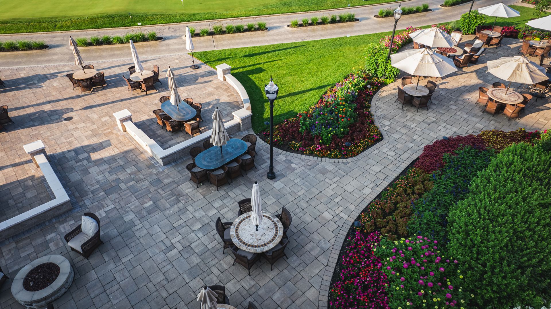 An aerial view of a patio with tables and umbrellas.