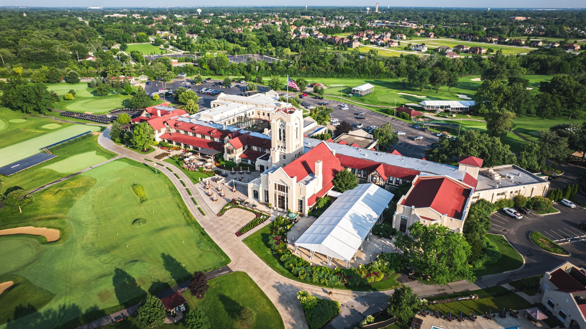 An aerial view of a large building with a red roof