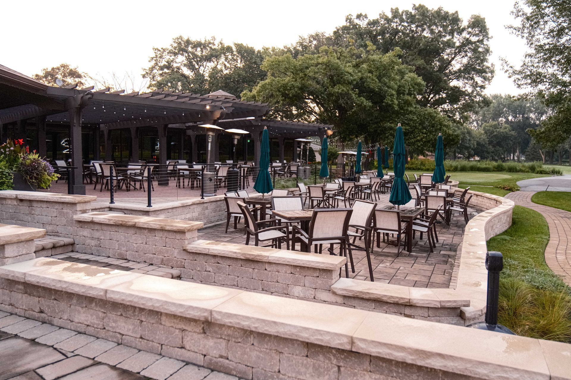 A patio area with tables and chairs and umbrellas