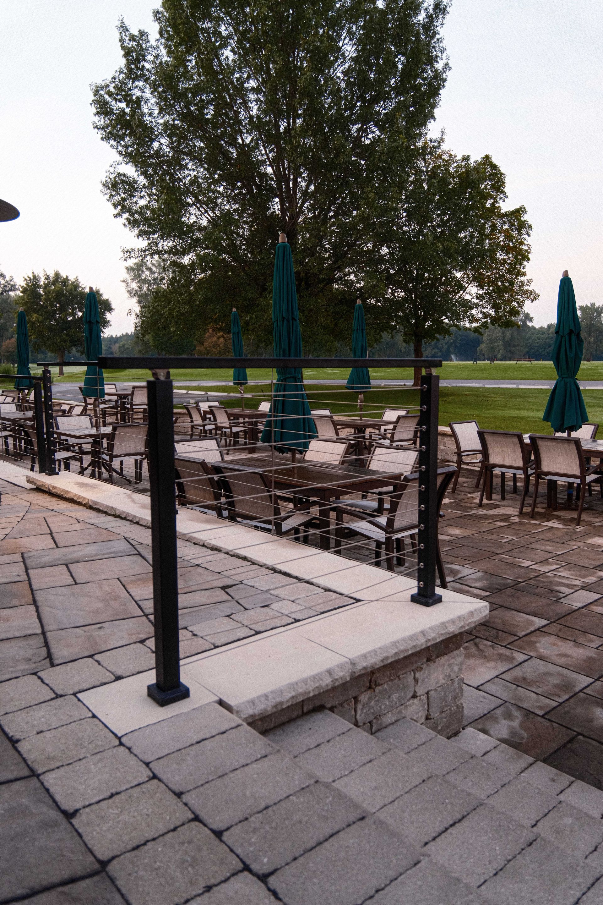 A patio with tables and chairs and umbrellas