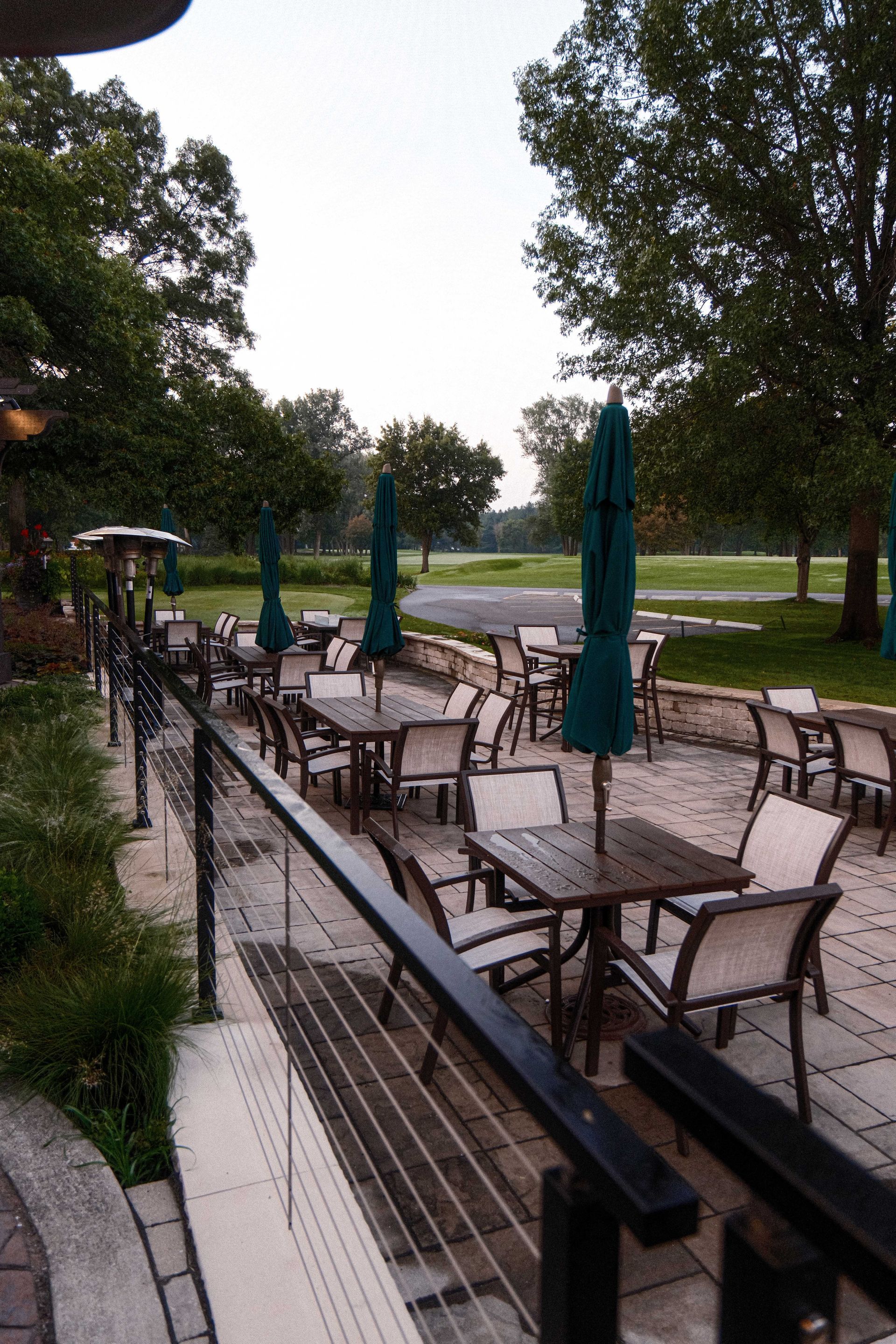 A patio with tables and chairs and umbrellas