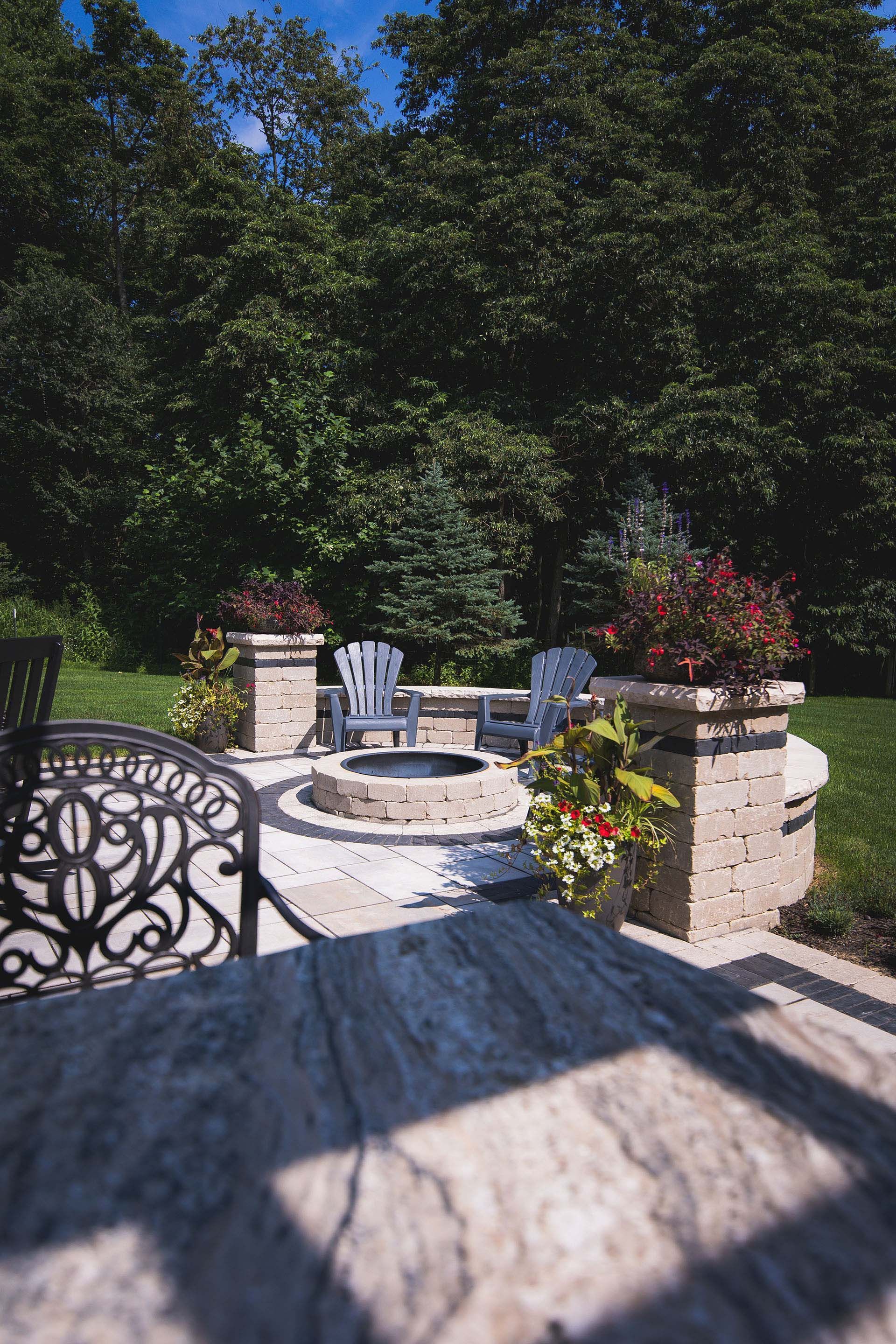 There is a fire pit in the middle of the backyard.