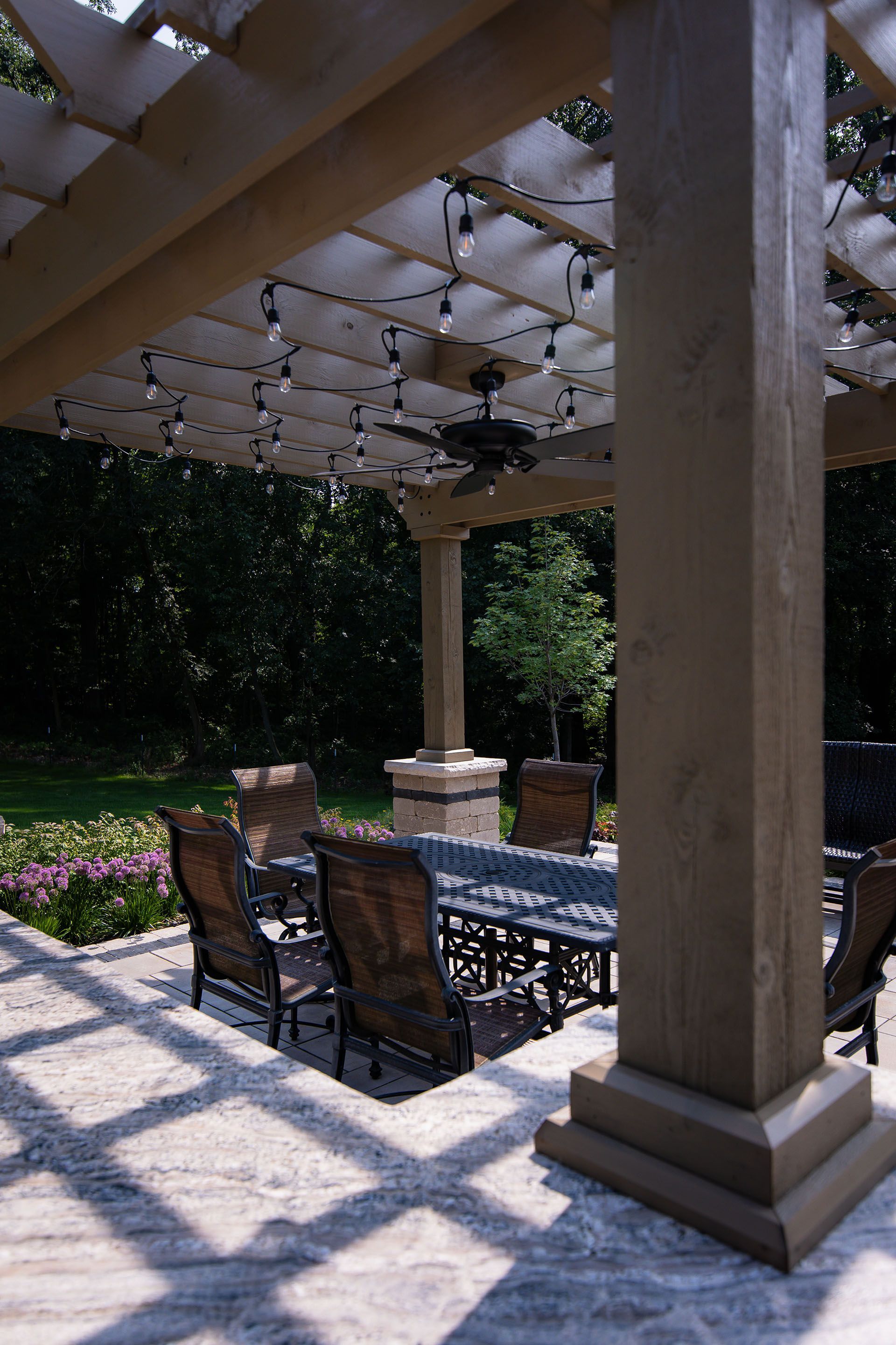 A patio with a table and chairs under a pergola