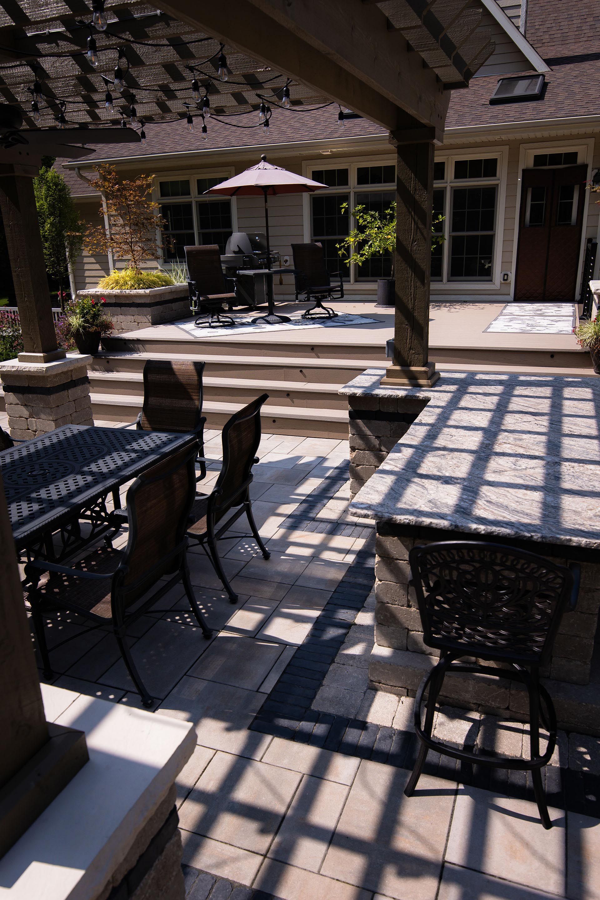 A patio with a table and chairs under a pergola